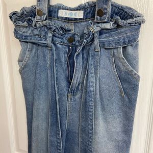 Trendy blue jean overalls.